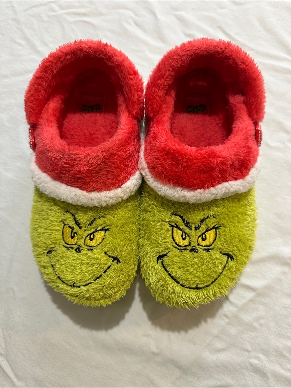 CROCS Kids Grinch Plush Slip-Ons in Lime Green and Red